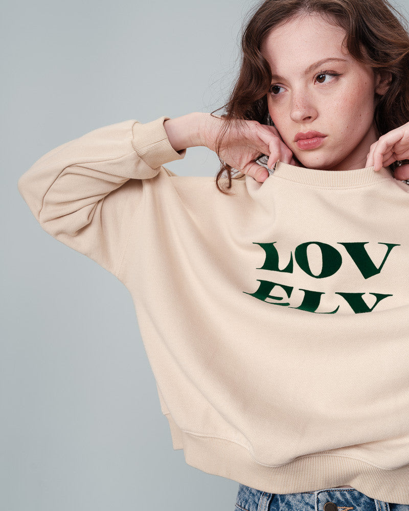 The&nbsp;NIGEL round neck sweatshirt by Grace &amp; Mila&nbsp;has a 'LOVELY' velvet print message in a beautiful hunter green on beige. Made from natural fibres, the warm and comfy&nbsp;NIGEL message sweater&nbsp;is a fall/winter essential. lemon cyprus boutique