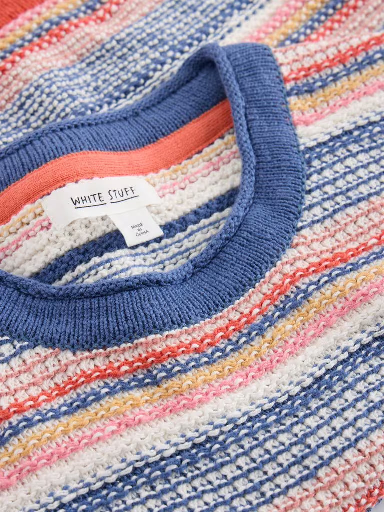 Close-up of a colorful striped sweater with 'White Stuff' label.