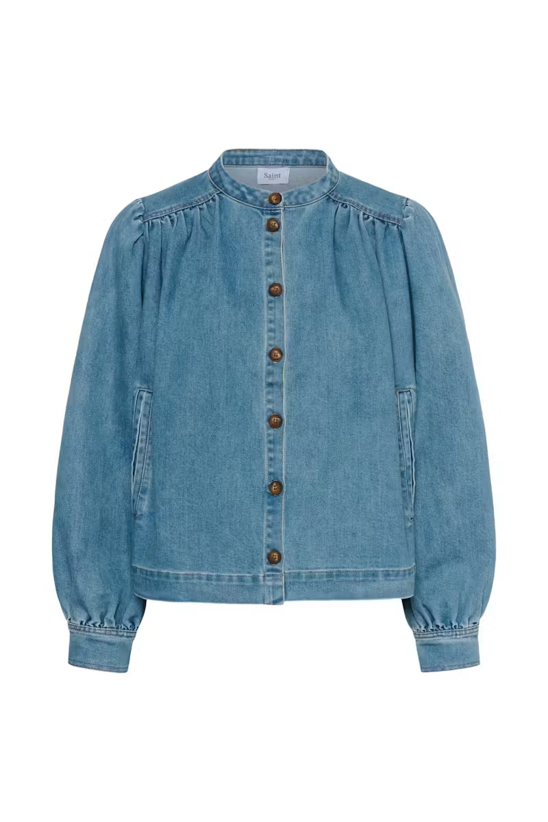 A light blue denim jacket with a stand collar, gathered long sleeves, and a button-up front with dark brown buttons, shown on a plain white background.