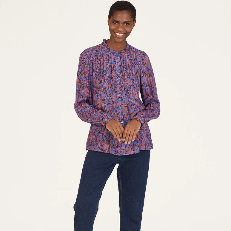 The Fawn Pintuck shirt from Thought is an eye-catching piece crafted from sustainable fabrics. Featuring a periwinkle blue hue with a nature-inspired pattern and a stylish frill neck, this blouse is elevated by pintuck details at the front and subtle puff sleeves.  lemon cyprus boutique