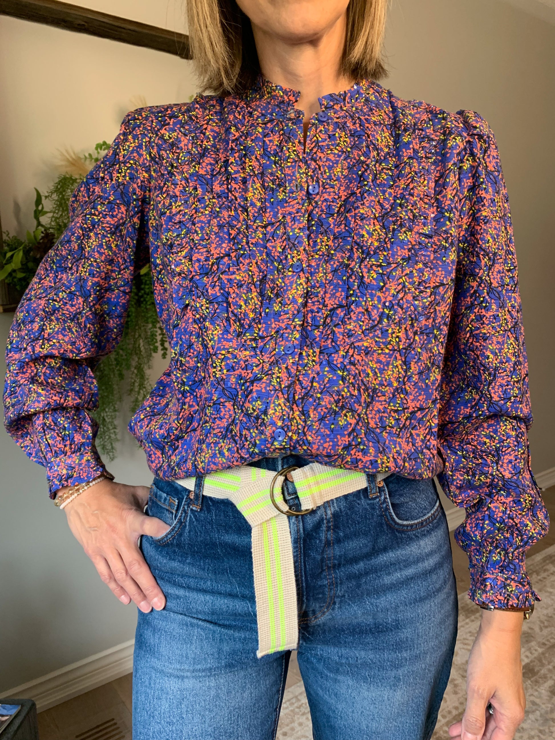 The Fawn Pintuck shirt from Thought is an eye-catching piece crafted from sustainable fabrics. Featuring a periwinkle blue hue with a nature-inspired pattern and a stylish frill neck, this blouse is elevated by pintuck details at the front and subtle puff sleeves.  lemon cyprus boutique