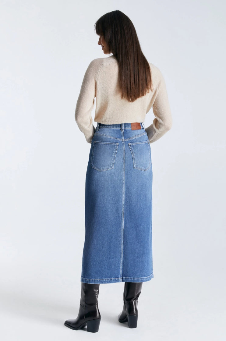 Experience the Valerie Denim Skirt by Cup of Joe - your ultimate choice for fashion and comfort. Its medium blue hue and sleek silhouette is sure to flatter any body type, while the longer length adds a touch of warmth in cooler temperatures. Boasting five pockets and a front slit, it's a practical and trendy addition to your wardrobe