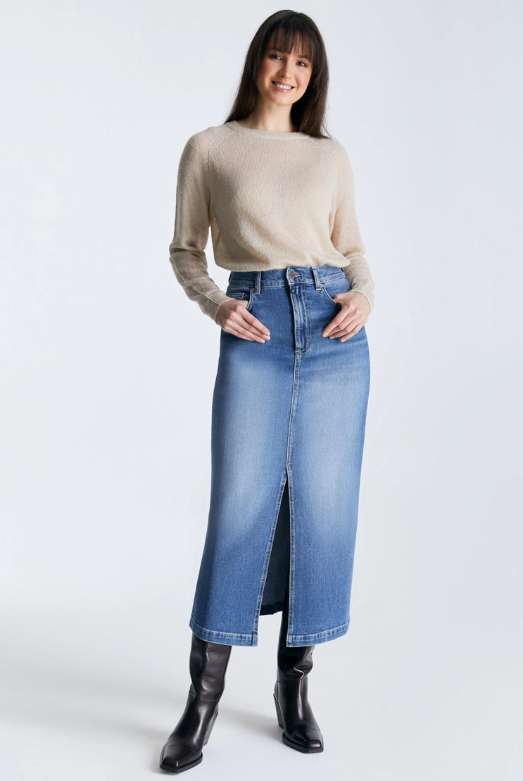 Experience the Valerie Denim Skirt by Cup of Joe - your ultimate choice for fashion and comfort. Its medium blue hue and sleek silhouette is sure to flatter any body type, while the longer length adds a touch of warmth in cooler temperatures. Boasting five pockets and a front slit, it's a practical and trendy addition to your wardrobe