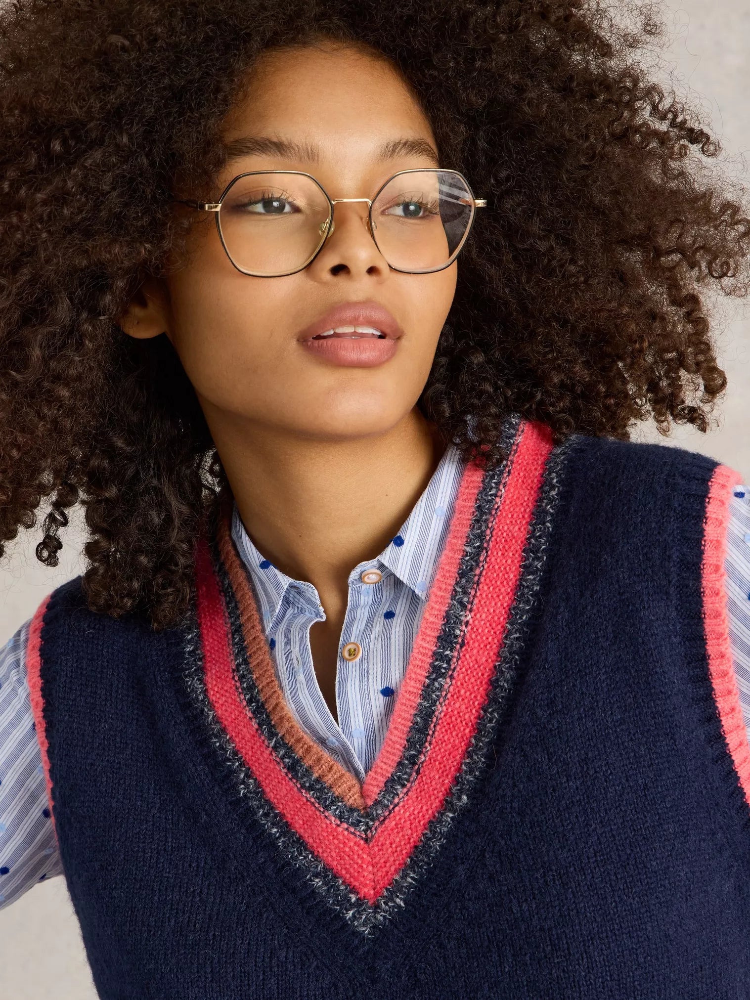 Be a standout in this cool V Neck Striped Vest by White Stuff. With a touch of quirkiness (the best ones always have it), this deep blue knitted vest features a unique mismatched stripe at the bottom and playful bright coral and pink tones at the top. 