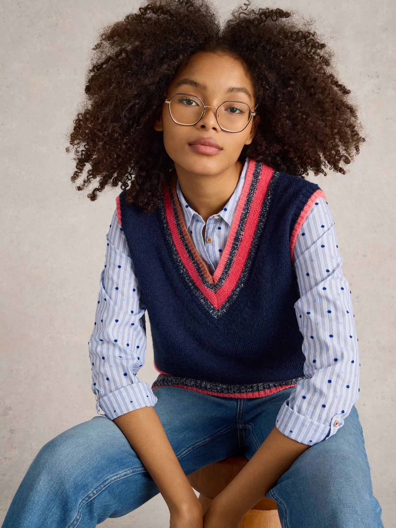 Be a standout in this cool V Neck Striped Vest by White Stuff. With a touch of quirkiness (the best ones always have it), this deep blue knitted vest features a unique mismatched stripe at the bottom and playful bright coral and pink tones at the top. 