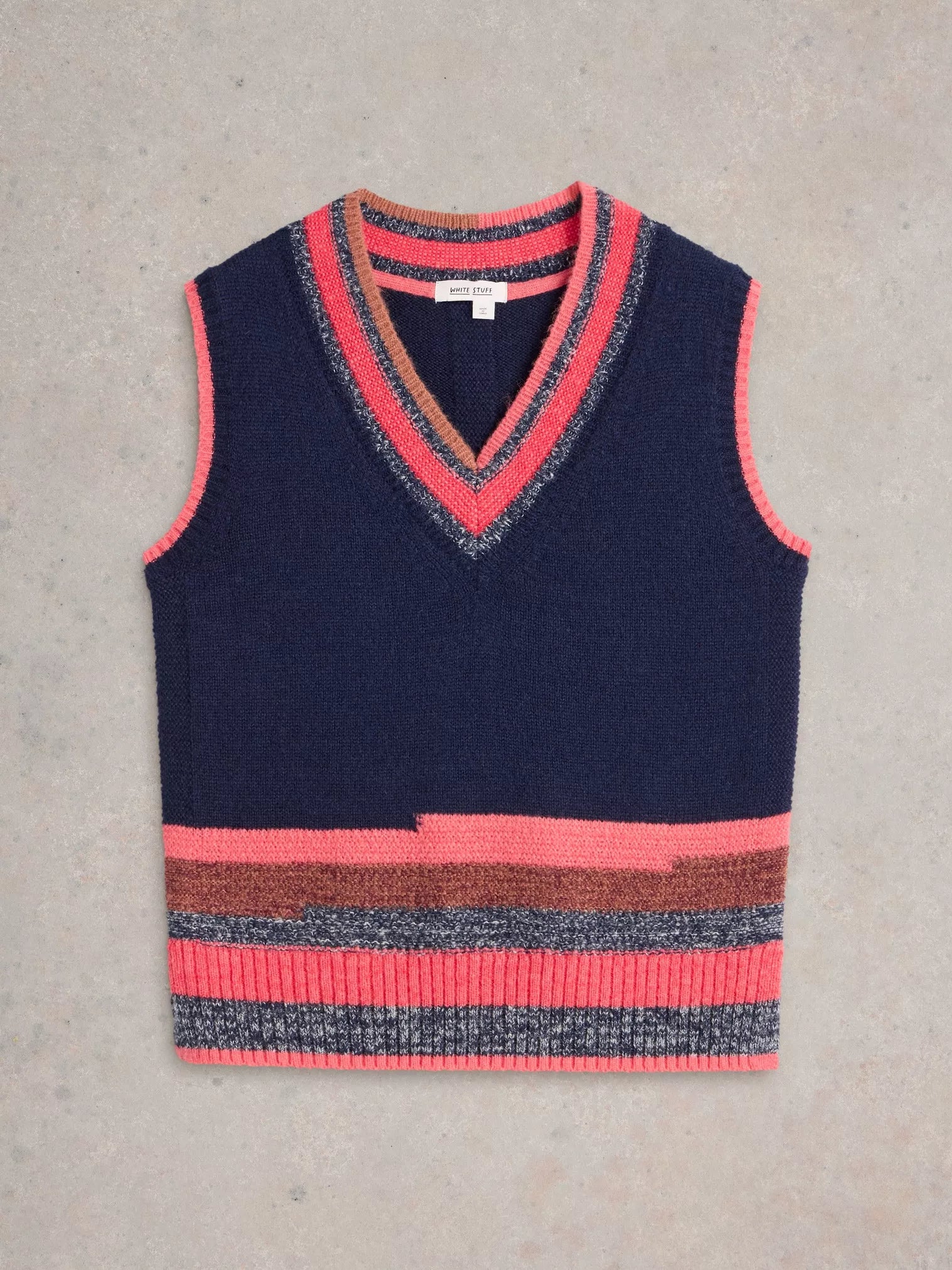 Be a standout in this cool V Neck Striped Vest by White Stuff. With a touch of quirkiness (the best ones always have it), this deep blue knitted vest features a unique mismatched stripe at the bottom and playful bright coral and pink tones at the top. 