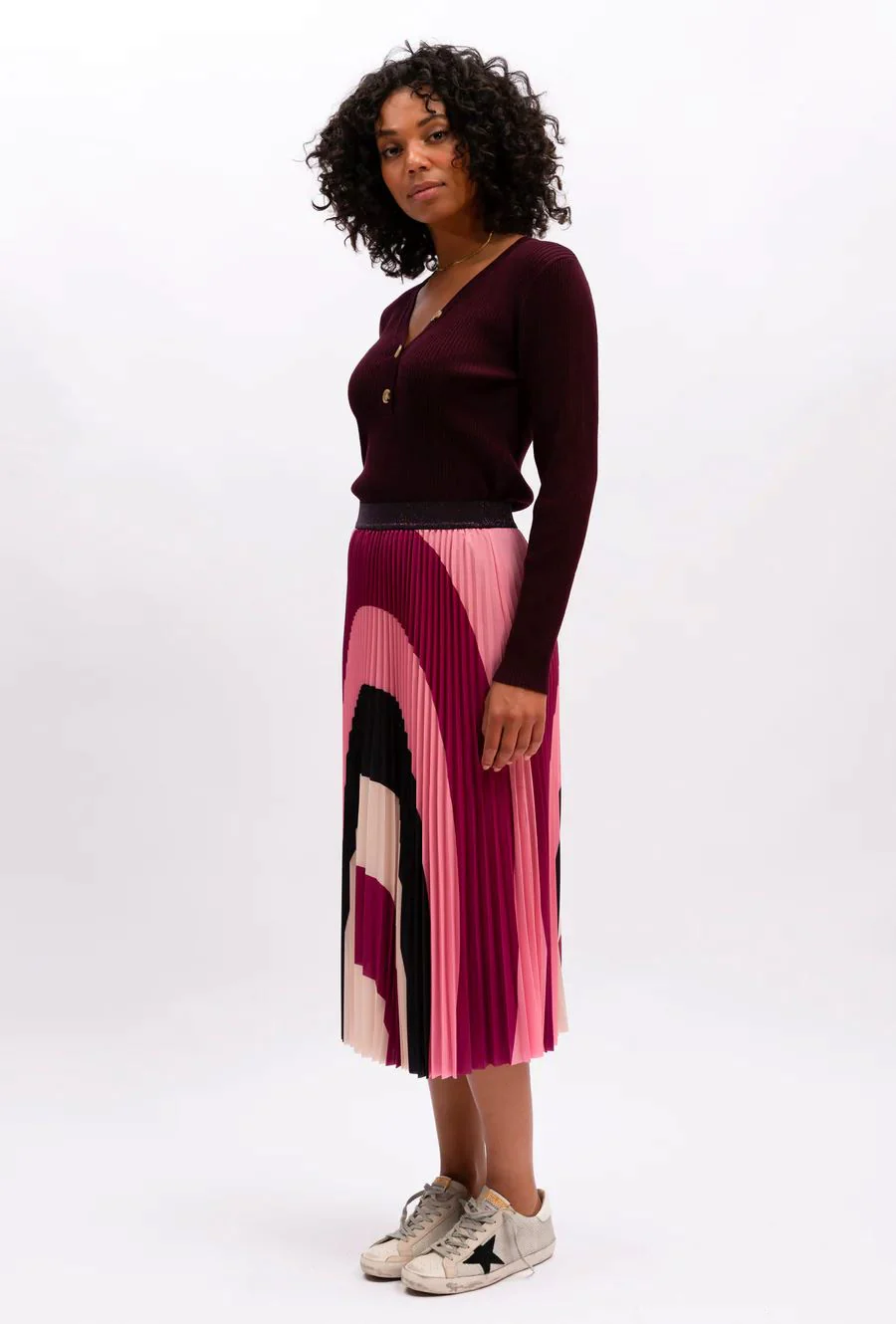 The Lilian Pleat Skirt by We Are The Others is now available in a lively and wavy sangria pattern, featuring pinks, black, and cream. Tailored from a soft and comfortable fabric, this skirt is perfect for any occasion. lemon cyprus boutique