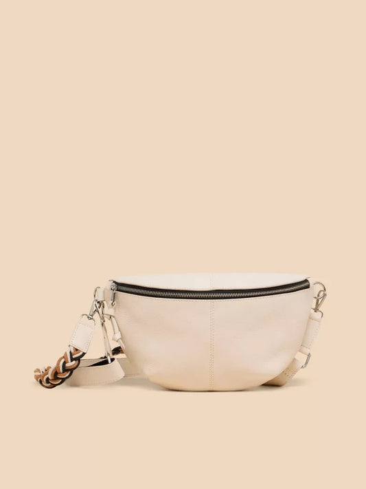 The versatile ivory Sebby leather sling bag by White Stuff comes with two straps — one leather, one plaited. There's nothing handier than going hands-free. Crafted from high-quality leather, the Sebby Leather Sling offers both style and convenience with its two straps. Enjoy the freedom of going hands-free while staying stylish with this versatile bag. Wear it crossbody for a chic casual look or wear it with the plaited arm strap for a dressier look.