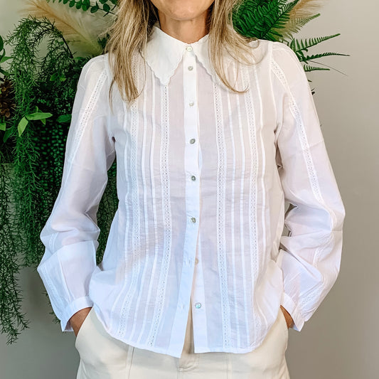 100% cotton white blouse. The scalloped detailing on the collar with the intricate and pleating details that run vertically down the front and arms of the blouse are stunning.