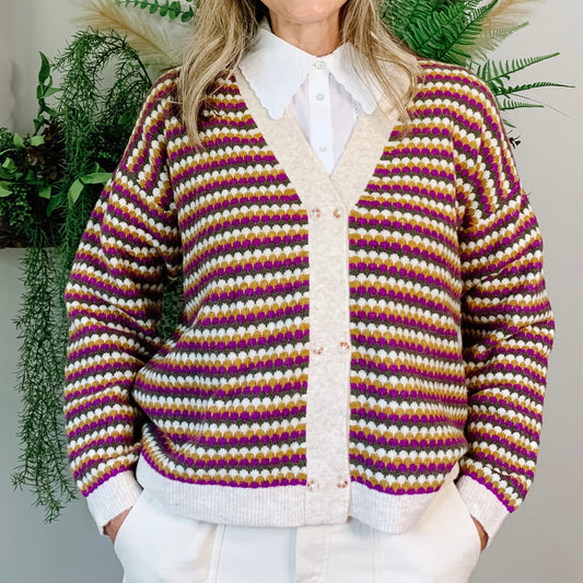 The Tonos Cardigan is a stunner! With the double button detail down the front and the beautiful pattern of deep fuschia, ochre and khaki greens on the oatmeal back drop.
